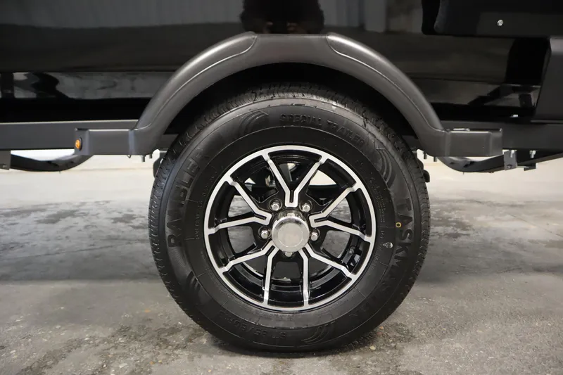 Slide: The Image of 2026 Lowe Fishing Machine 1625WT trailer wheel with black alloy rim and Rambler tire. - 45