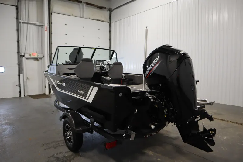 Slide: The Image of 2026 Lowe Fishing Machine 1625WT boat with Mercury engine in a garage setting. - 6