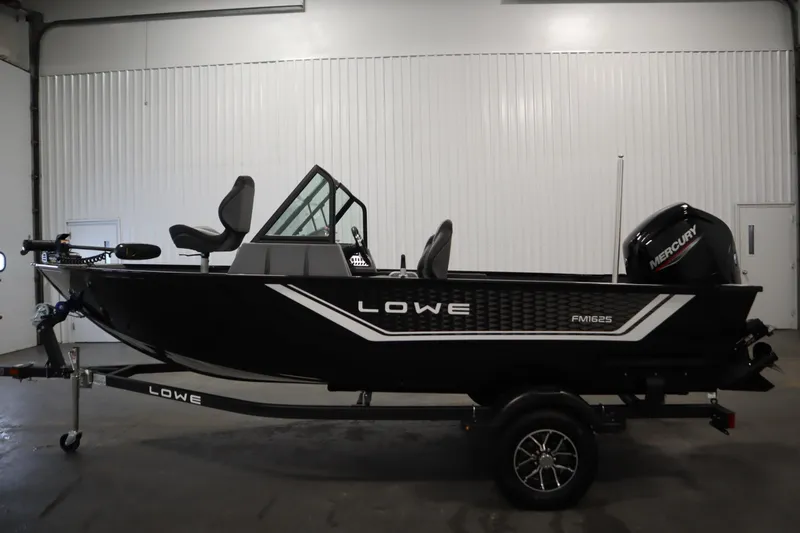 Slide: The Image of 2026 Lowe Fishing Machine 1625WT boat in a showroom, side view. - 7