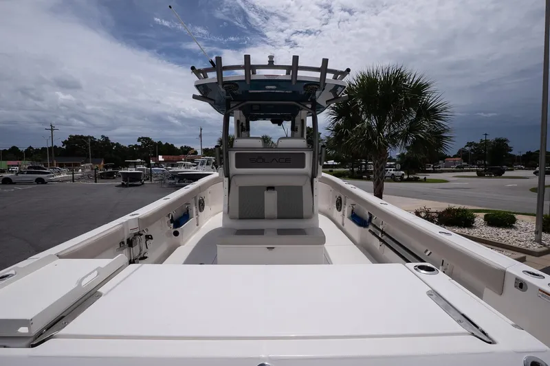 Slide: The Image of 2026 Solace 30 CS boat with spacious deck and modern design, parked outdoors. - 10