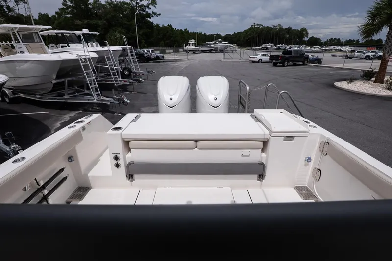 Slide: The Image of 2026 Solace 30 CS boat interior with dual engines, parked in a marina. - 13