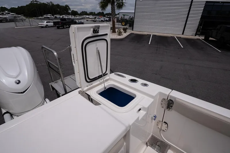 Slide: The Image of 2026 Solace 30 CS boat with open storage compartment in a parking lot. - 16