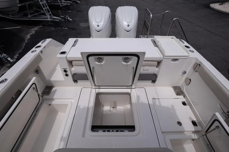 Slide: The Image of 2026 Solace 30 CS boat deck with storage compartments and twin engines. - 18