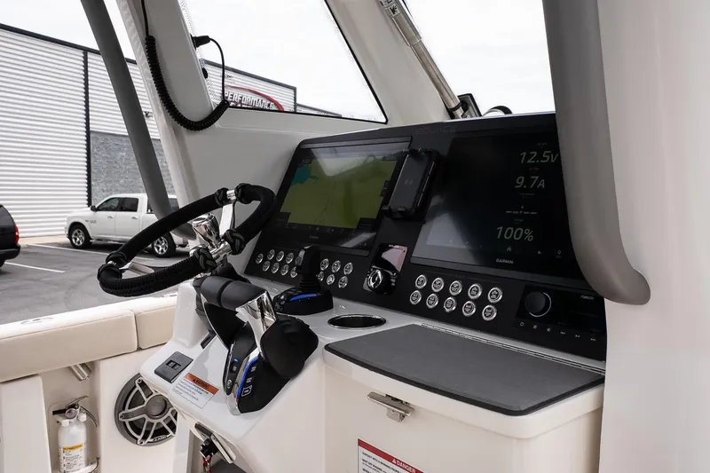 Slide: The Image of Helm of 2026 Solace 30 CS boat with advanced navigation displays and controls. - 19