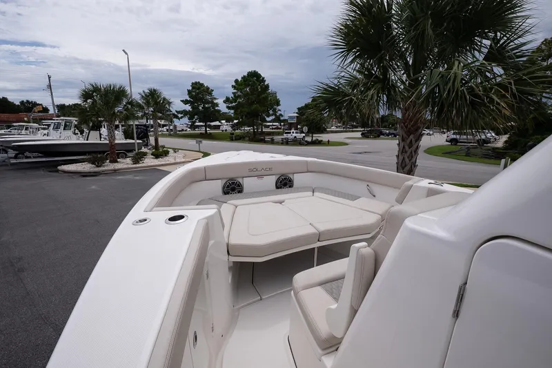 Slide: The Image of 2026 Solace 30 CS boat with spacious seating, docked near palm trees. - 24
