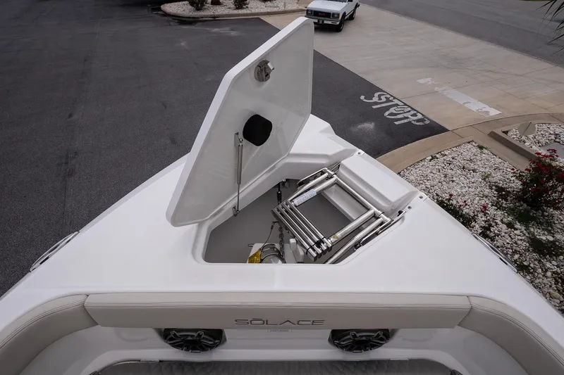 Slide: The Image of Open hatch on 2026 Solace 30 CS boat, revealing storage compartment and ladder. - 27