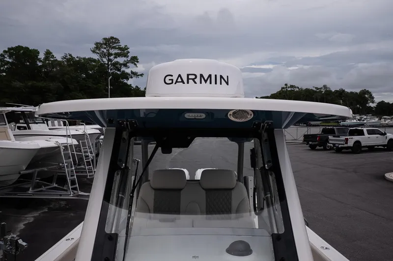 Slide: The Image of 2026 Solace 30 CS boat with Garmin equipment, docked in a marina. - 29
