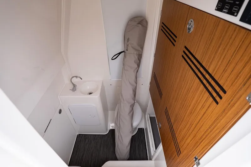 Slide: The Image of Compact bathroom in 2026 Solace 30 CS boat with wooden cabinetry and sink. - 33