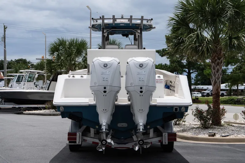 Slide: The Image of 2026 Solace 30 CS boat with dual outboard engines, parked outdoors. - 6