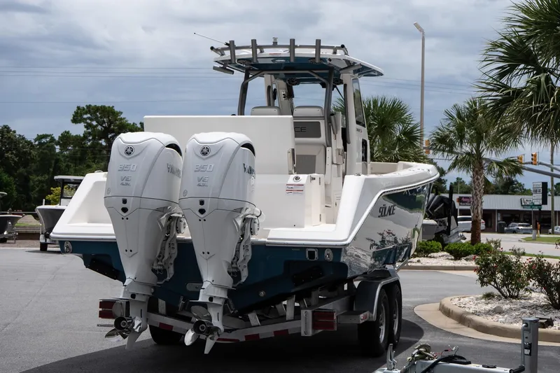 Slide: The Image of 2026 Solace 30 CS boat with dual Yamaha 350 engines on a trailer. - 7