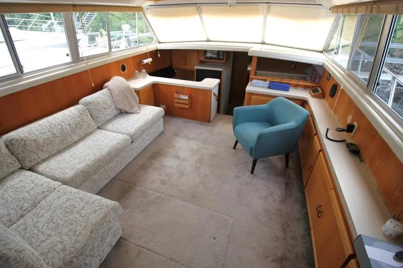 Slide: The Image of Interior of 1990 Silverton 40 Aft Cabin yacht with sofa, chair, and cabinetry. - 16