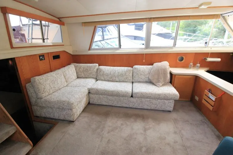 Slide: The Image of 1990 Silverton 40 Aft Cabin interior with patterned sofa and large windows. - 17