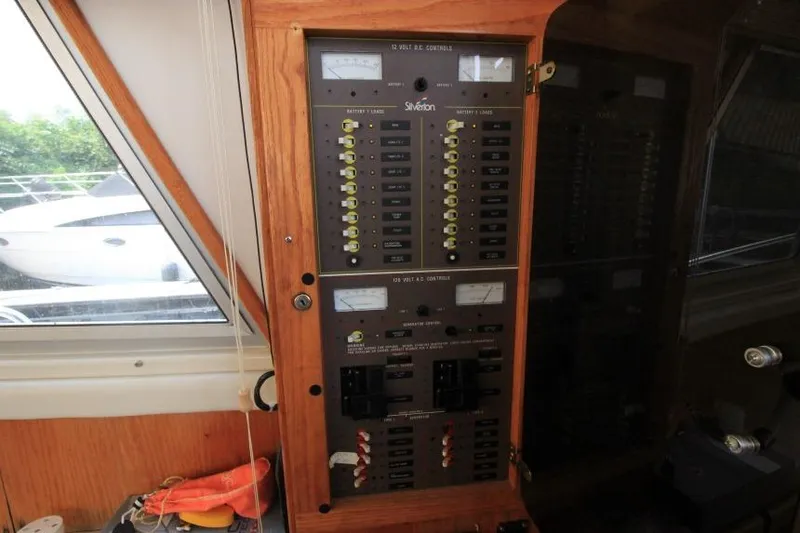 Slide: The Image of Electrical control panel inside 1990 Silverton 40 Aft Cabin boat, featuring various switches and meters. - 20