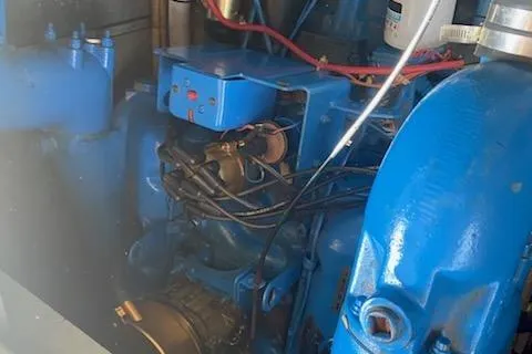 Slide: The Image of Engine compartment of a 1990 Silverton 40 Aft Cabin boat, featuring blue components. - 37