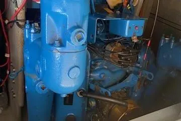 Slide: The Image of Engine compartment of a 1990 Silverton 40 Aft Cabin boat, featuring blue machinery. - 38