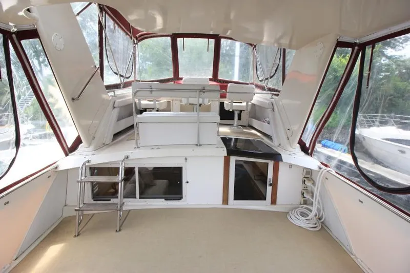 Slide: The Image of 1990 Silverton 40 Aft Cabin interior with seating, windows, and storage compartments. - 9