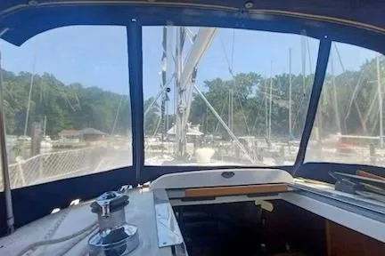 Slide: The Image of Interior view of a 2003 Hunter 356 sailboat cockpit with marina background. - 3