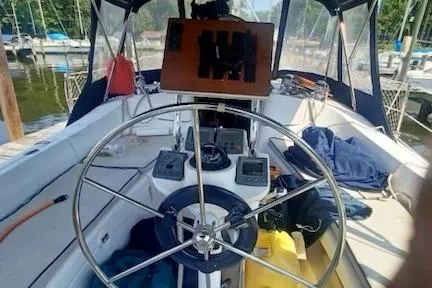 Slide: The Image of 2003 Hunter 356 sailboat cockpit with steering wheel and navigation instruments. - 5
