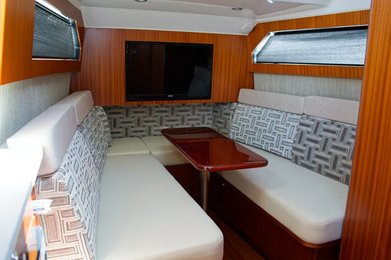 Slide: The Image of Luxurious interior of 2022 Pursuit S 428 Sport boat with cozy seating and TV. - 12