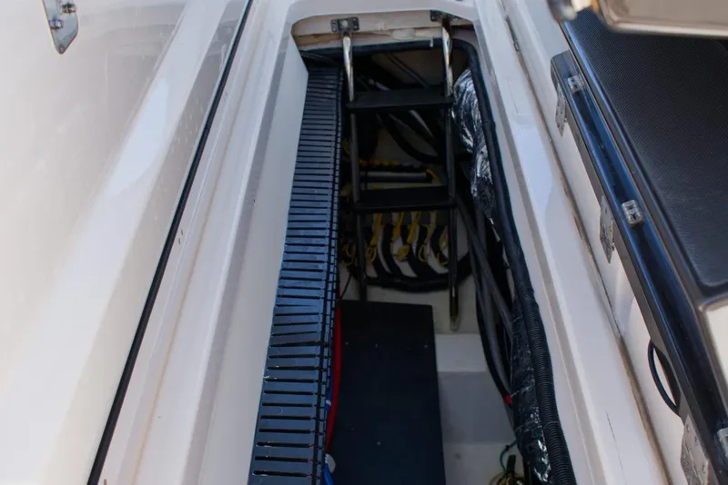 Slide: The Image of 2022 Pursuit S 428 Sport boat interior with ladder and storage compartment. - 14