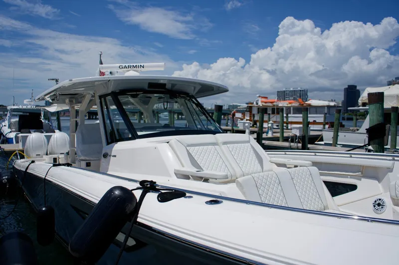 Slide: The Image of 2022 Pursuit S 428 Sport boat docked, featuring sleek design and luxurious seating. - 21