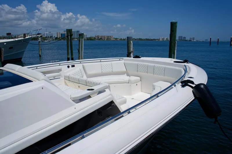 Slide: The Image of 2022 Pursuit S 428 Sport boat docked with luxurious seating and ocean view. - 3