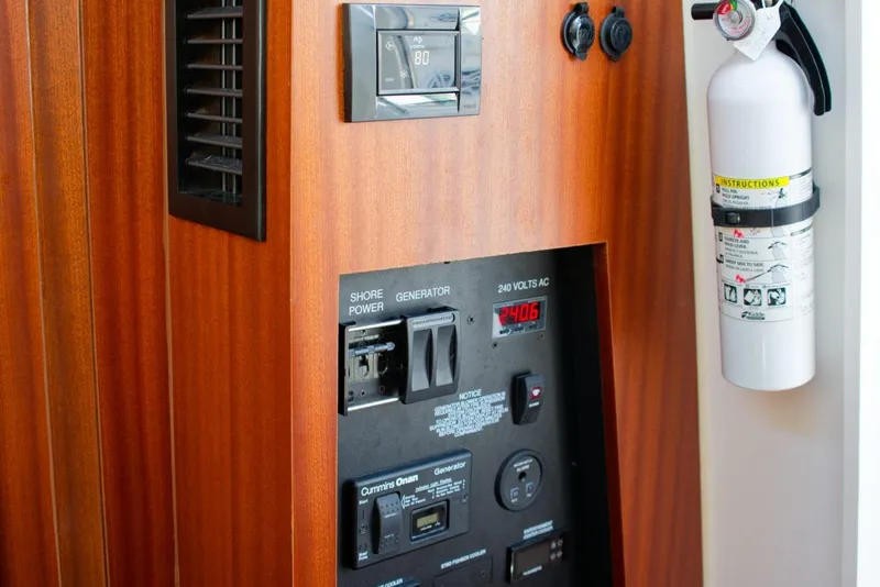 Slide: The Image of Control panel and fire extinguisher on 2022 Pursuit S 428 Sport boat. - 31