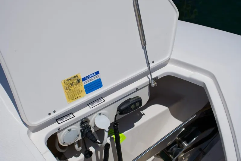 Slide: The Image of 2022 Pursuit S 428 Sport boat compartment with raw and fresh water connections. - 5