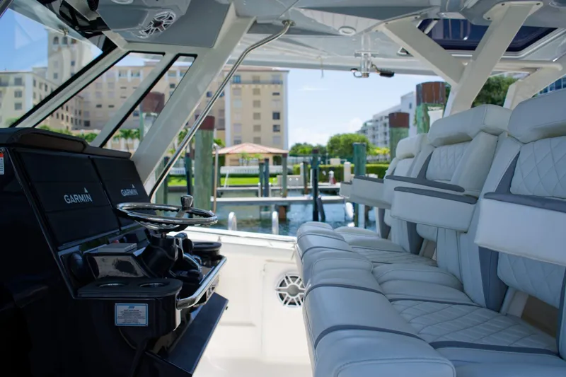 Slide: The Image of Interior of 2022 Pursuit S 428 Sport boat with luxurious seating and Garmin navigation. - 6