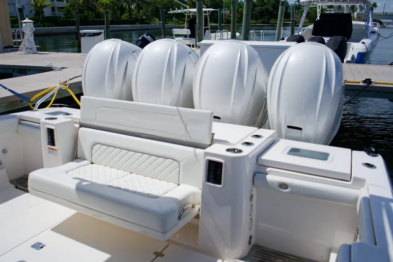 Slide: The Image of 2022 Pursuit S 428 Sport boat with four powerful outboard engines docked at marina. - 9