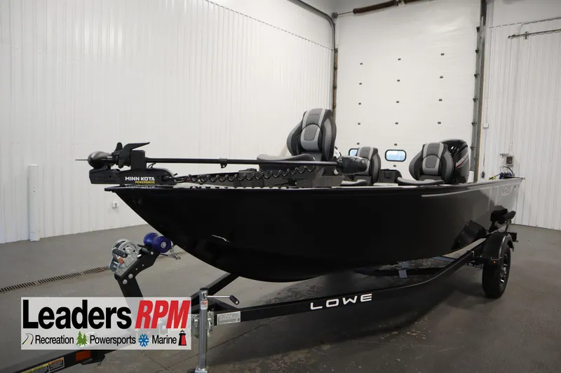 The Image of 2026 Lowe Fishing Machine 1675SC boat in showroom, featuring Minn Kota trolling motor. - 0
