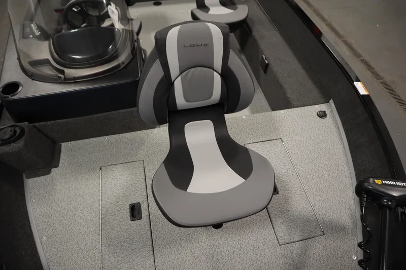 Slide: The Image of 2026 Lowe Fishing Machine 1675SC interior with gray seating and console. - 15