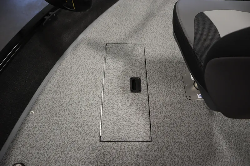 Slide: The Image of 2026 Lowe Fishing Machine 1675SC interior with storage compartment and seat detail. - 16