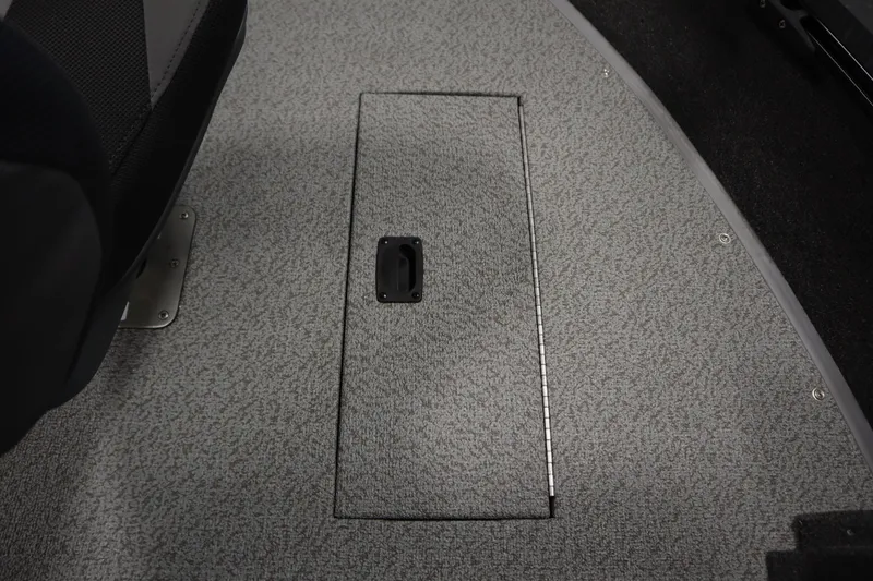 Slide: The Image of 2026 Lowe Fishing Machine 1675SC interior with storage compartment and seat. - 18