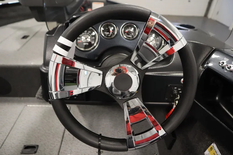 Slide: The Image of 2026 Lowe Fishing Machine 1675SC steering wheel and dashboard close-up. - 22