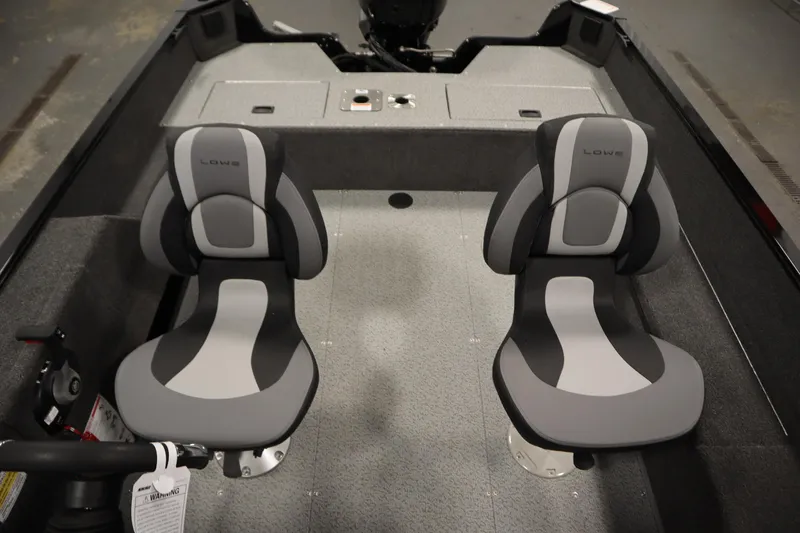 Slide: The Image of 2026 Lowe Fishing Machine 1675SC interior with two gray and black seats. - 29