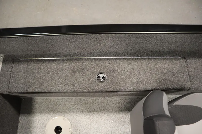 Slide: The Image of Interior view of 2026 Lowe Fishing Machine 1675SC boat, featuring carpeted flooring and seating. - 30