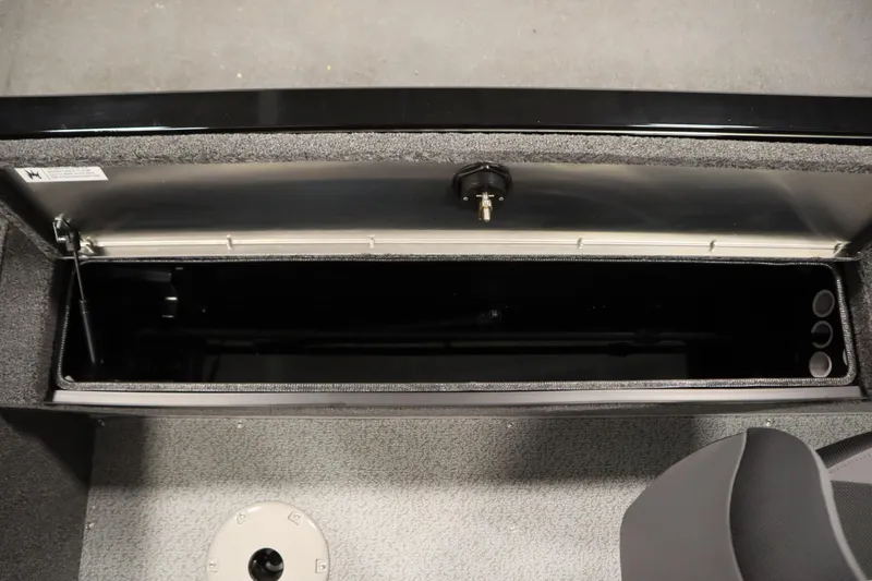 Slide: The Image of 2026 Lowe Fishing Machine 1675SC storage compartment, open and empty, with gray interior. - 31