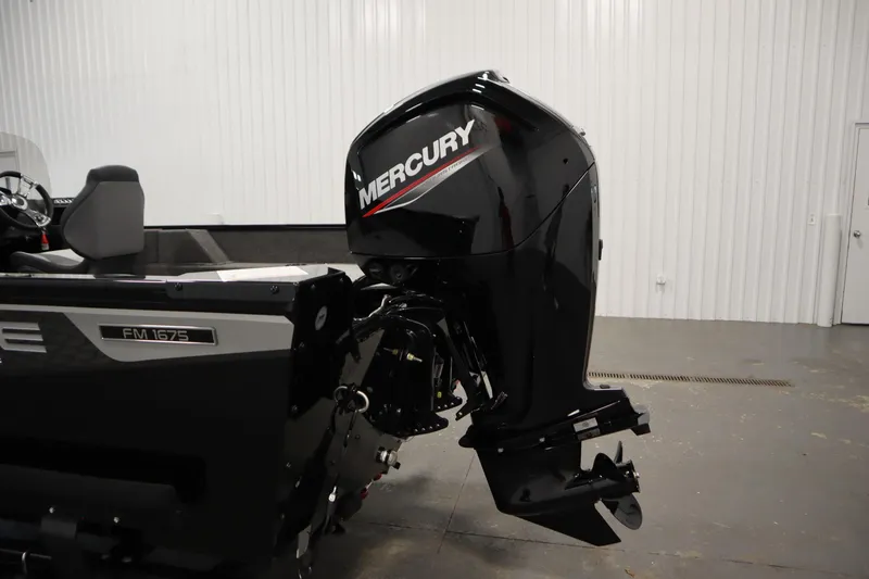 Slide: The Image of 2026 Lowe Fishing Machine 1675SC with Mercury outboard motor in a showroom. - 37