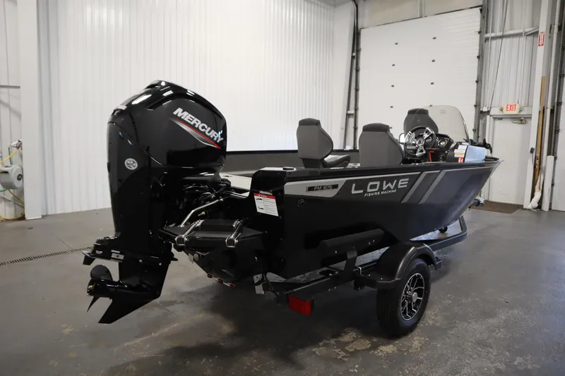 Slide: The Image of 2026 Lowe Fishing Machine 1675SC boat with Mercury engine in a garage setting. - 4
