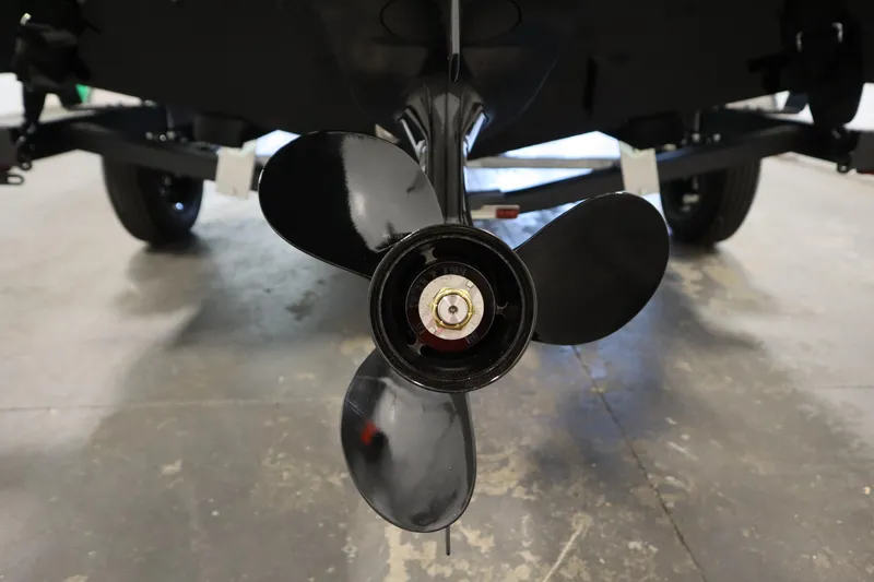 Slide: The Image of 2026 Lowe Fishing Machine 1675SC boat propeller close-up in a garage setting. - 40