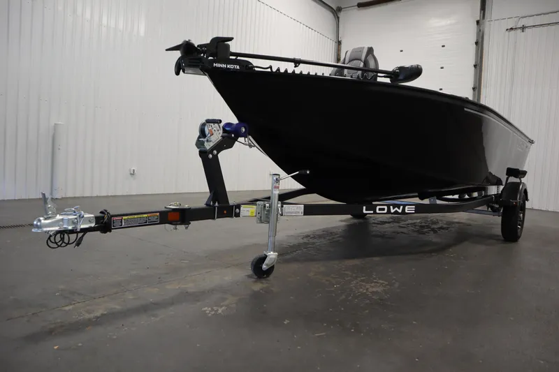 Slide: The Image of 2026 Lowe Fishing Machine 1675SC on trailer in indoor setting. - 42