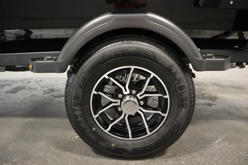 Slide: The Image of 2026 Lowe Fishing Machine 1675SC trailer wheel with black alloy rim and Rambler tire. - 43