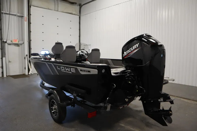 Slide: The Image of 2026 Lowe Fishing Machine 1675SC boat with Mercury engine in a garage setting. - 6