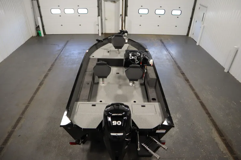 Slide: The Image of 2026 Lowe Fishing Machine 1675SC boat in a garage, featuring a Mercury 90 engine. - 9