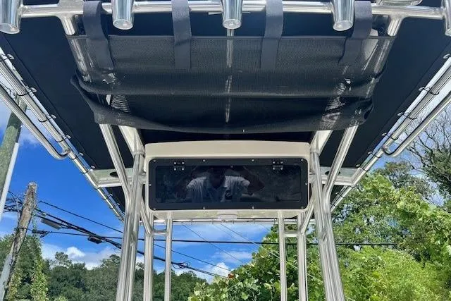 Slide: The Image of 2025 Key West 203 FS boat canopy and rod holders against a clear blue sky. - 12