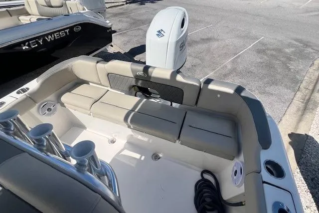Slide: The Image of 2025 Key West 203 FS boat interior with seating and Suzuki outboard motor. - 13