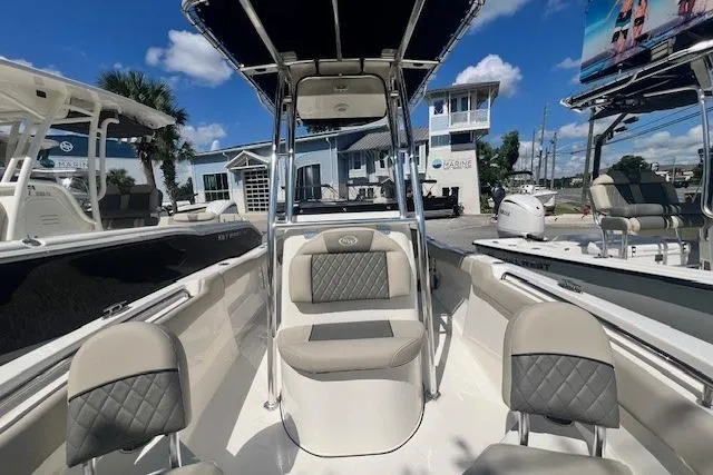 Slide: The Image of 2025 Key West 203 FS boat interior with seating, under a clear blue sky. - 8