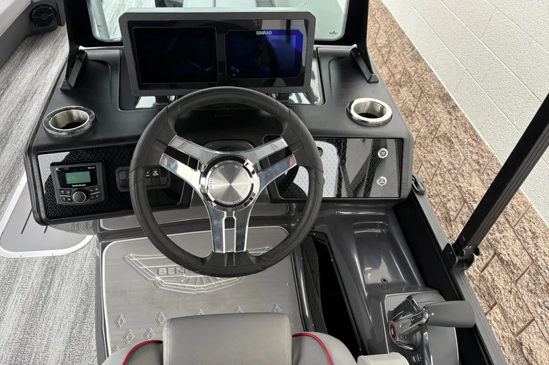 Slide: The Image of 2026 Bennington 24 MFB boat dashboard with steering wheel and digital displays. - 11