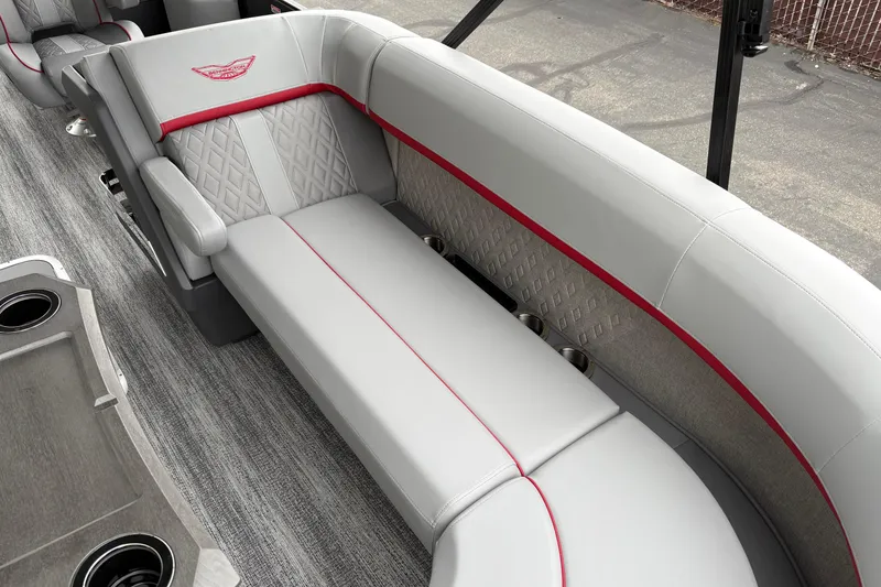 Slide: The Image of Luxurious seating on 2026 Bennington 24 MFB boat, featuring elegant gray upholstery with red accents. - 16